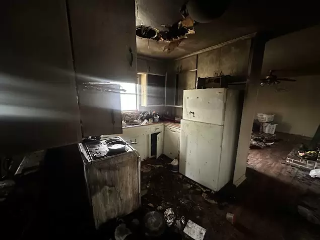 Interior of a home severely damaged by fire, smoke, and soot